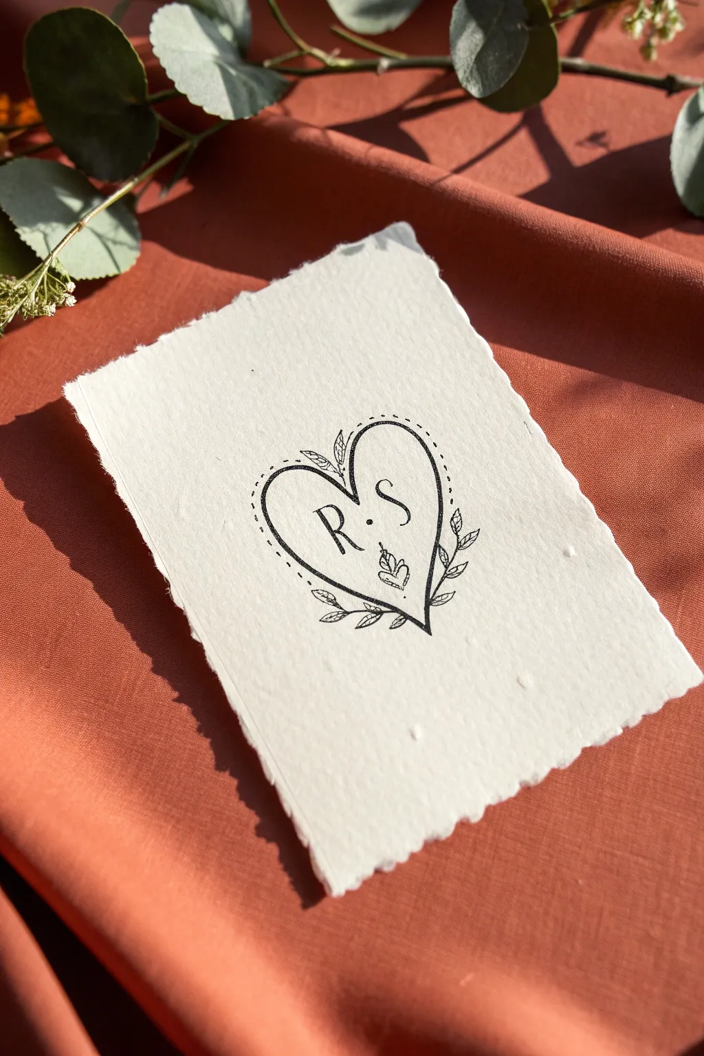 A minimalist heart keepsake sketch with monogram-style initials and a curved date detail