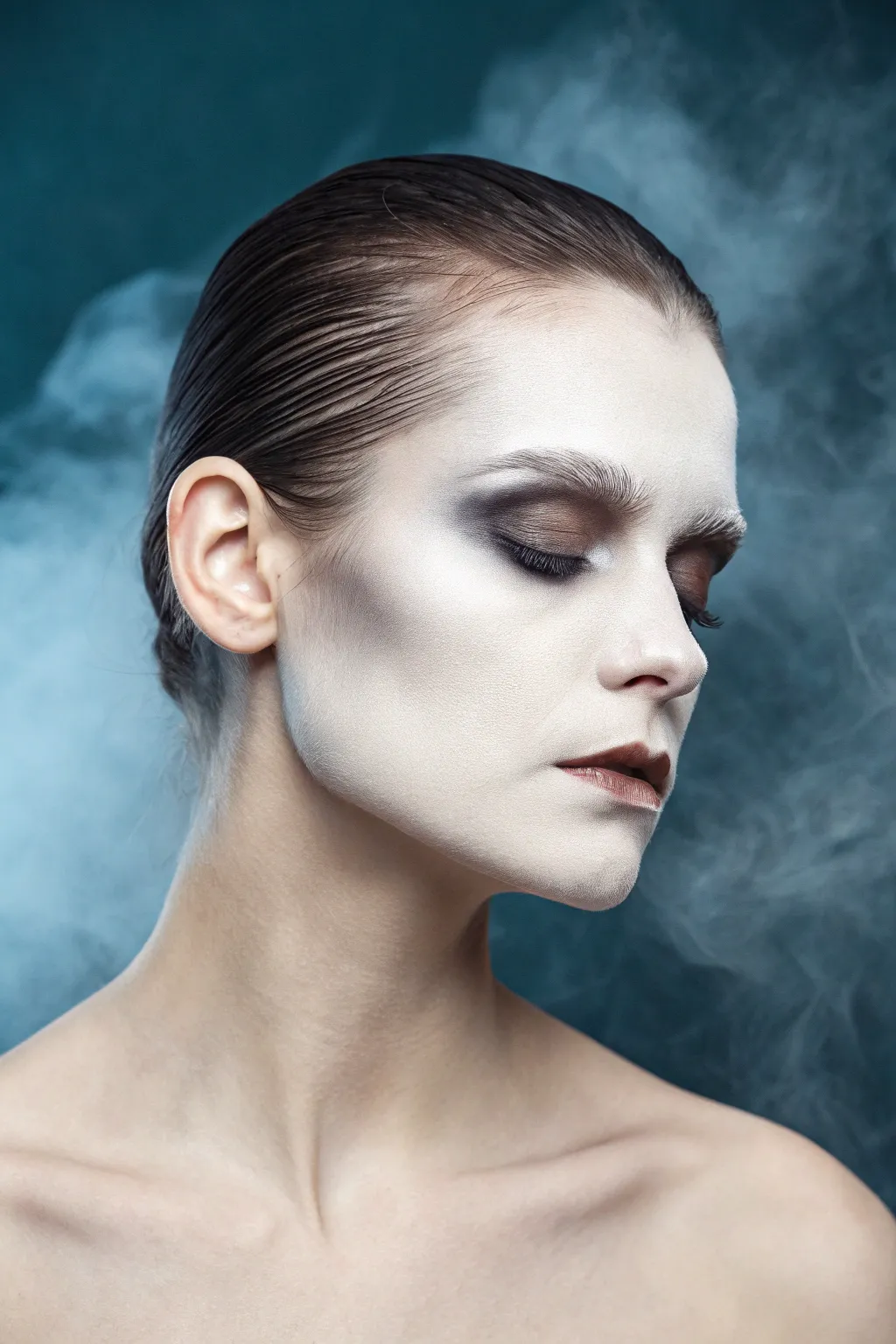 Soft haunted ghost fade face paint with misty base, smoky shadows, and an airy jawline wisp