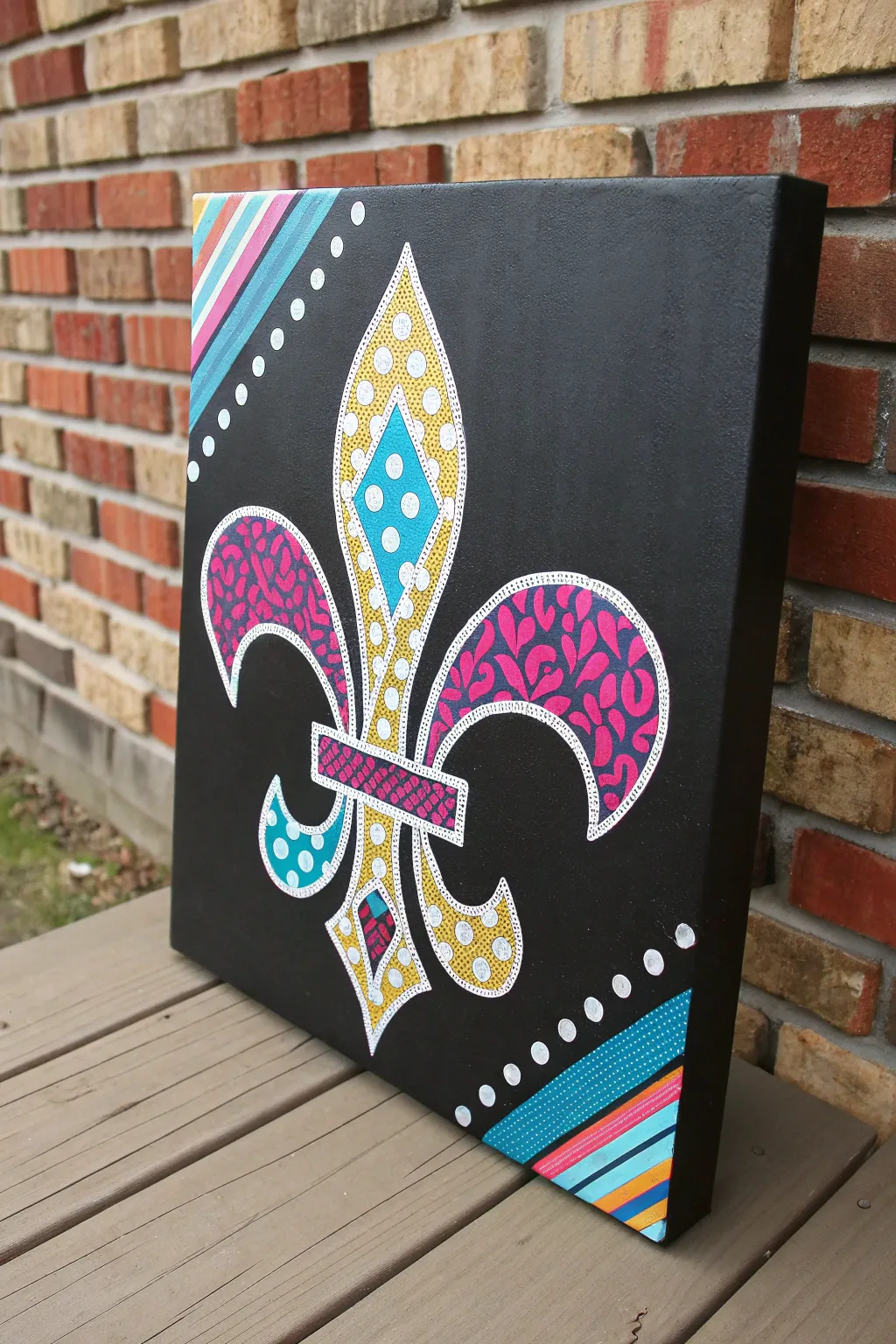 Bold pop-art fleur de lis with playful patterns and striking color blocks on matte black
