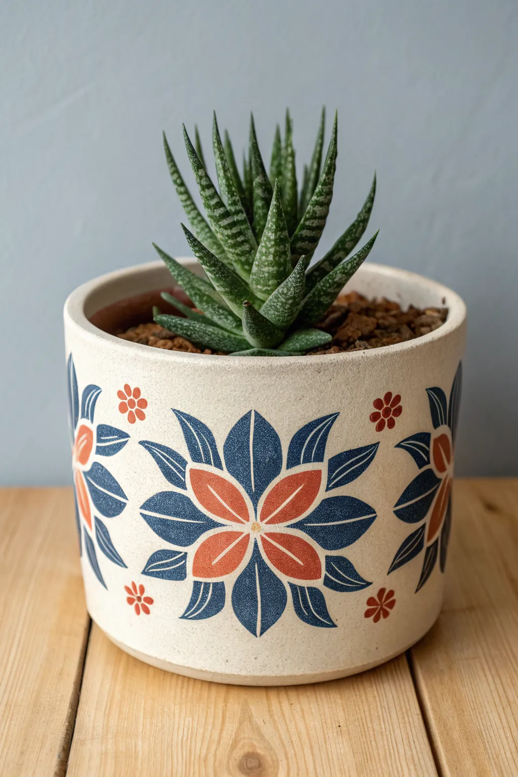 Two-color graphic blooms on a handmade planter for a bold, minimalist flower pottery idea