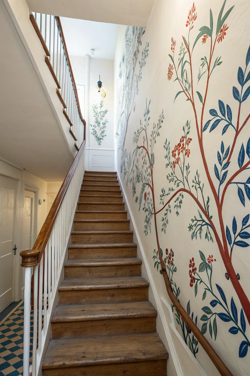 A seamless mural climbing the stairwell wall, tying floors together with bold, calm color.