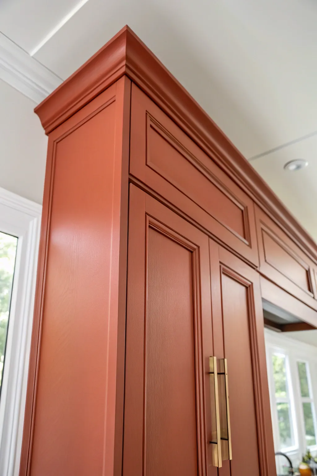 Color-match crown and trim to your cabinets for a seamless built-in wall effect with bold warmth.