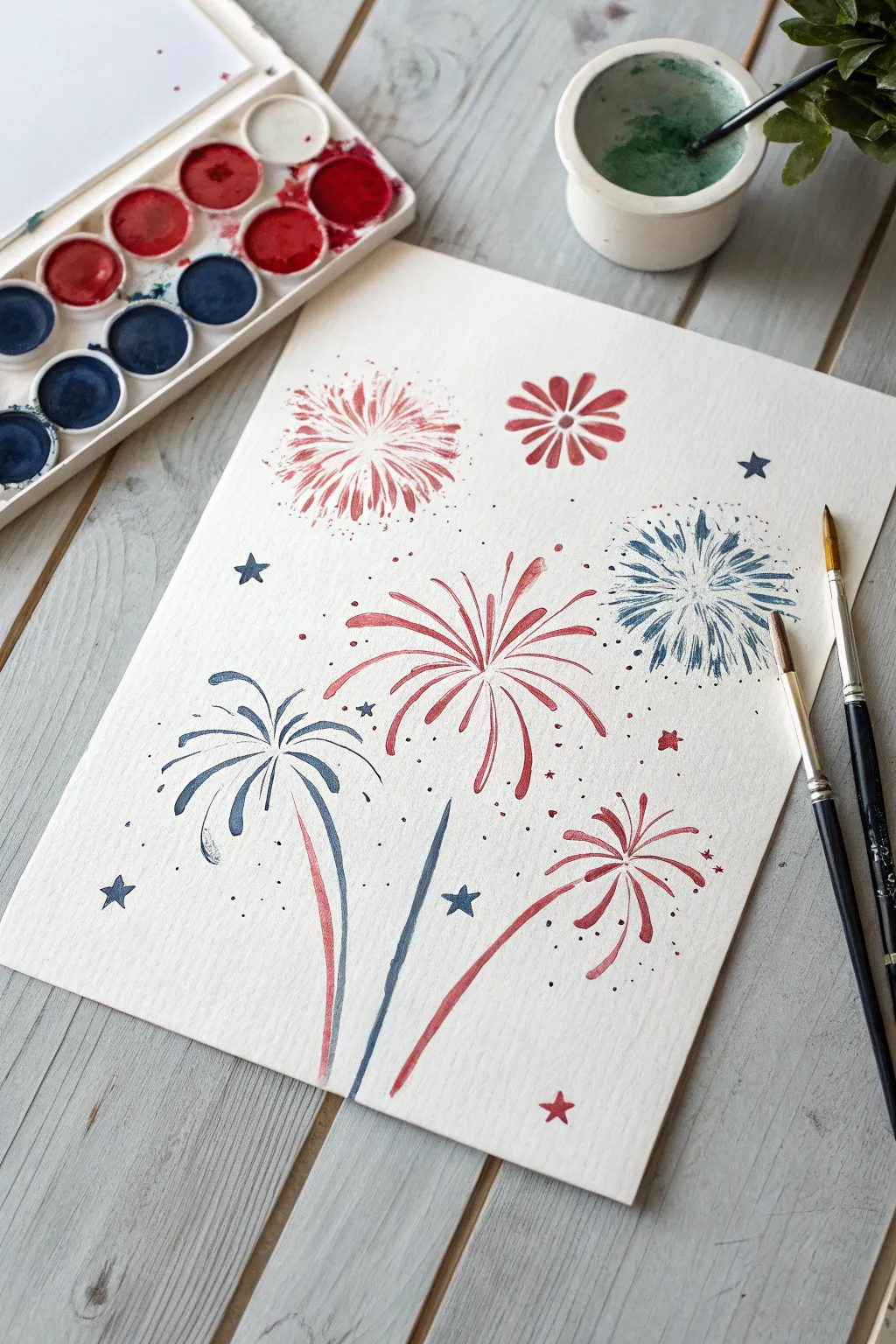 Marble-painted red, white, and blue fireworks burst artwork, minimalist Memorial Day craft inspo