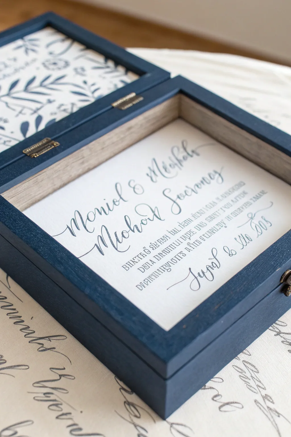 Wedding keepsake memory box lid with abstract vow script pattern and minimalist centerpiece