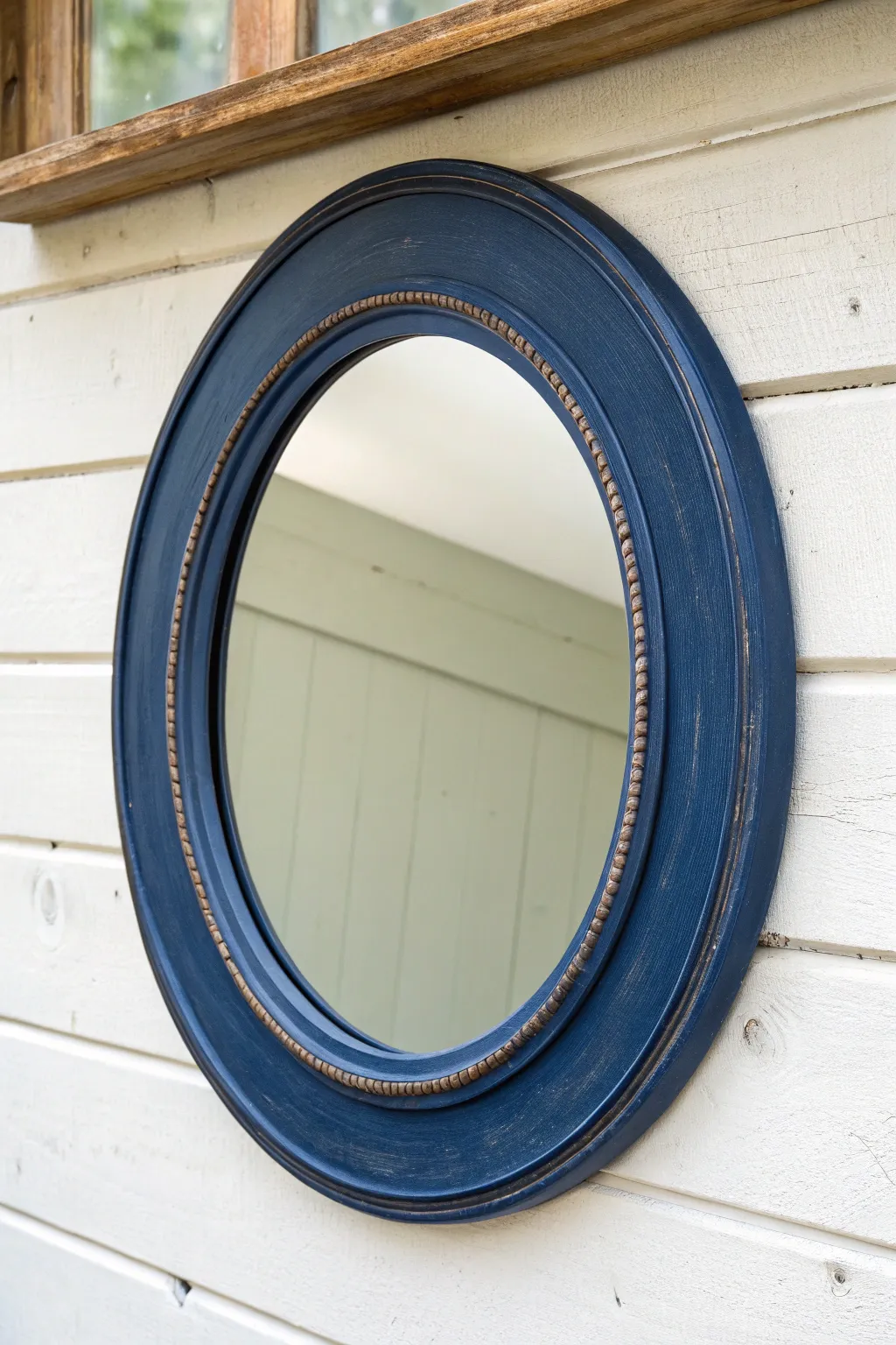Minimalist painted mirror frame with a subtle stenciled border for a refined boho look