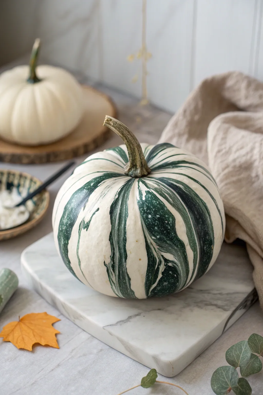 Marbled pumpkins with dreamy swirled paint for a chic minimalist-boho autumn centerpiece.