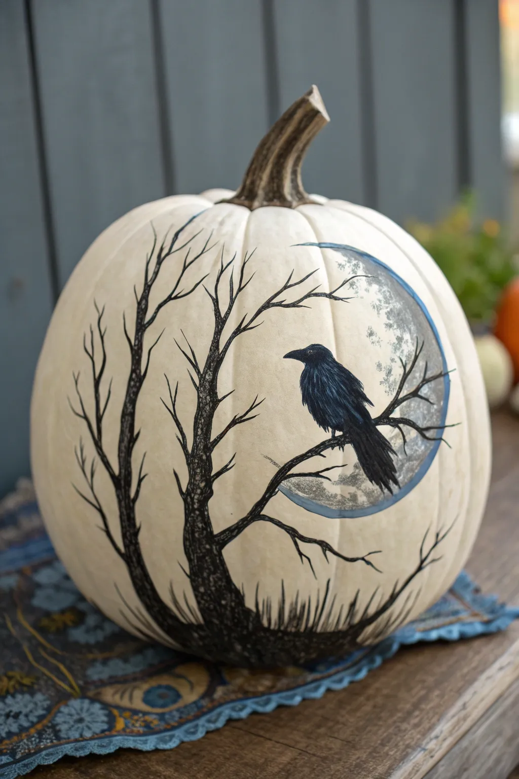 Raven on a moonlit pumpkin with cool blue feather highlights for a chic gothic Halloween vibe