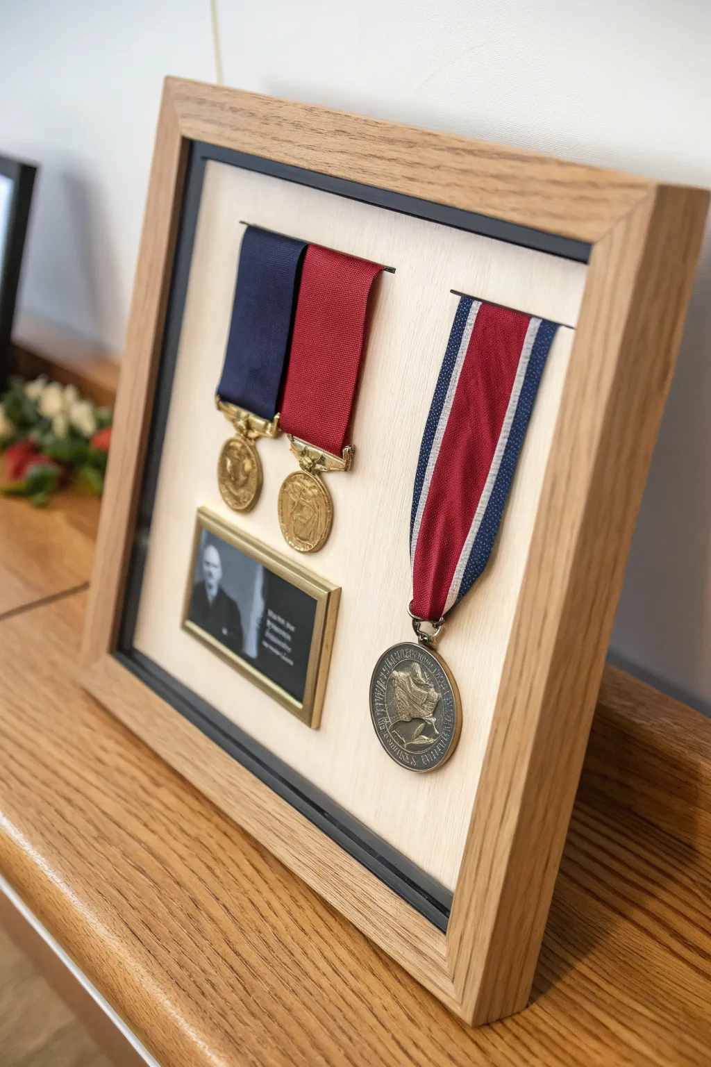 Minimal medal shadow box with ribbons and photo, Scandinavian calm with bold color contrast.