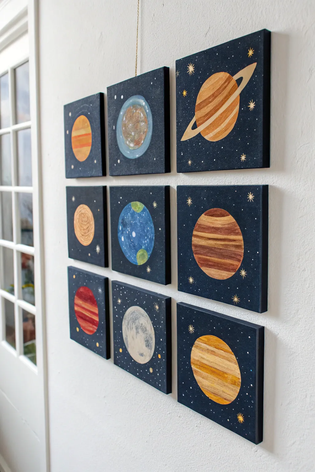Mini planet tiles in solar system order for a bold, minimalist boho gallery wall