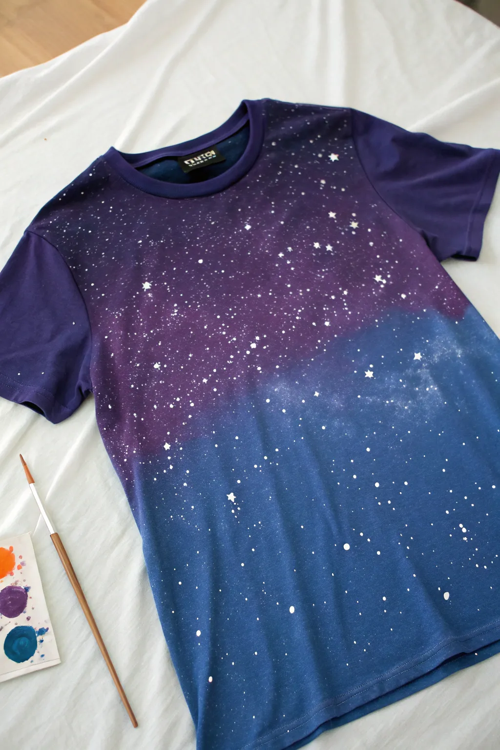 Night sky galaxy T shirt with bold indigo violet blend and delicate white star splatter