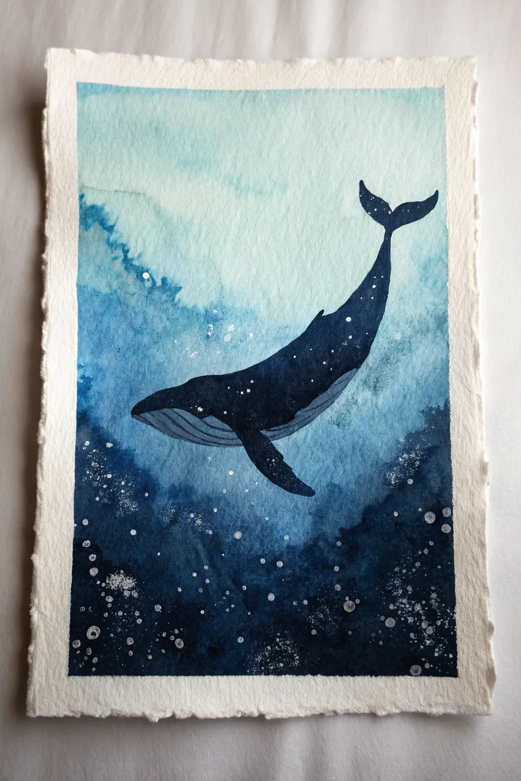 Easy underwater painting idea: striking whale silhouette in deep indigo water with soft speckled glow