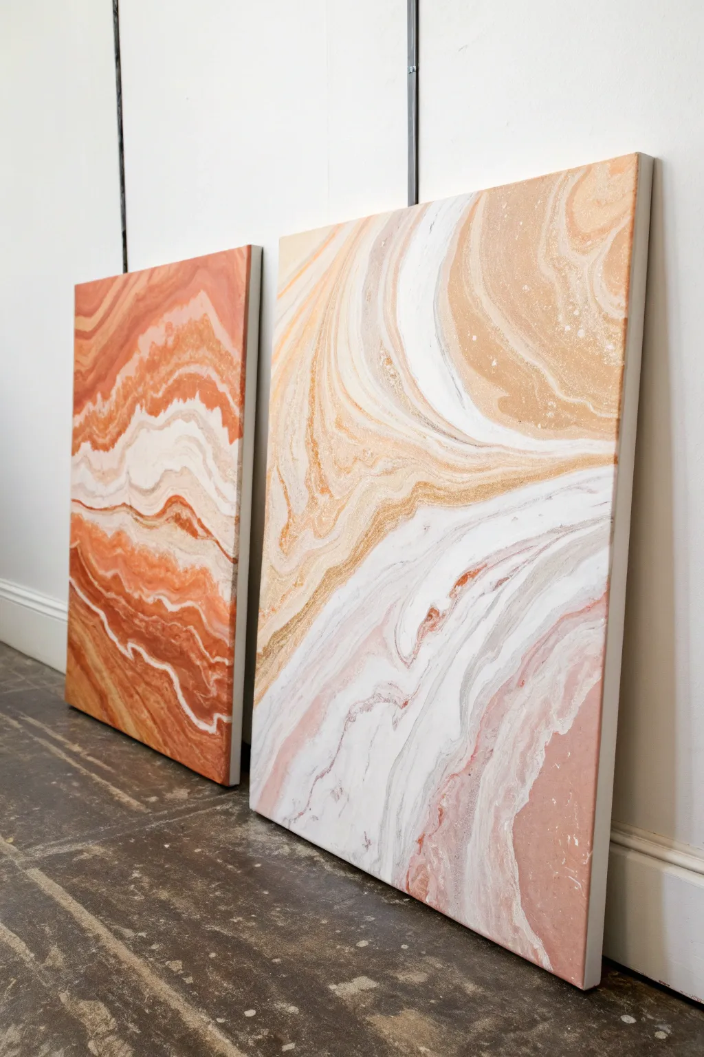 Two aligned canvases with flowing paint pour ribbons drifting seamlessly across the gap.