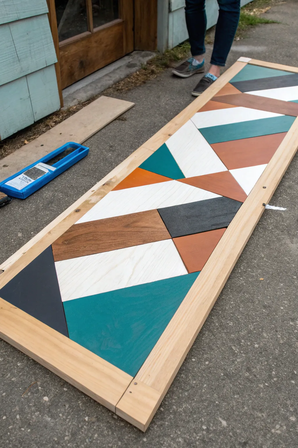 Bold acrylic geometry on raw wood grain with crisp tape lines for a minimalist boho look