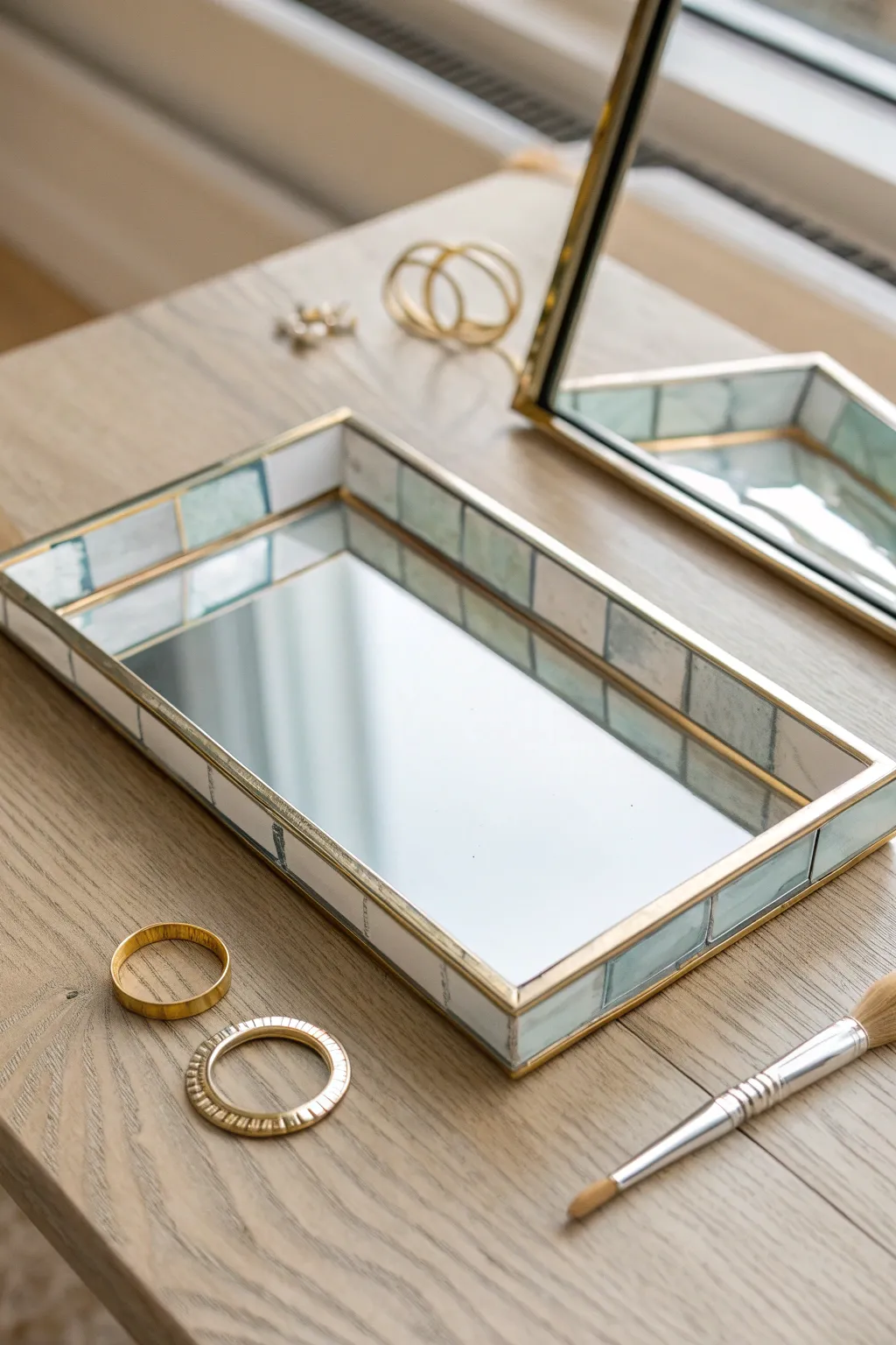 Mirror-finish glass tray with hand-painted frame details for a chic minimalist studio vibe