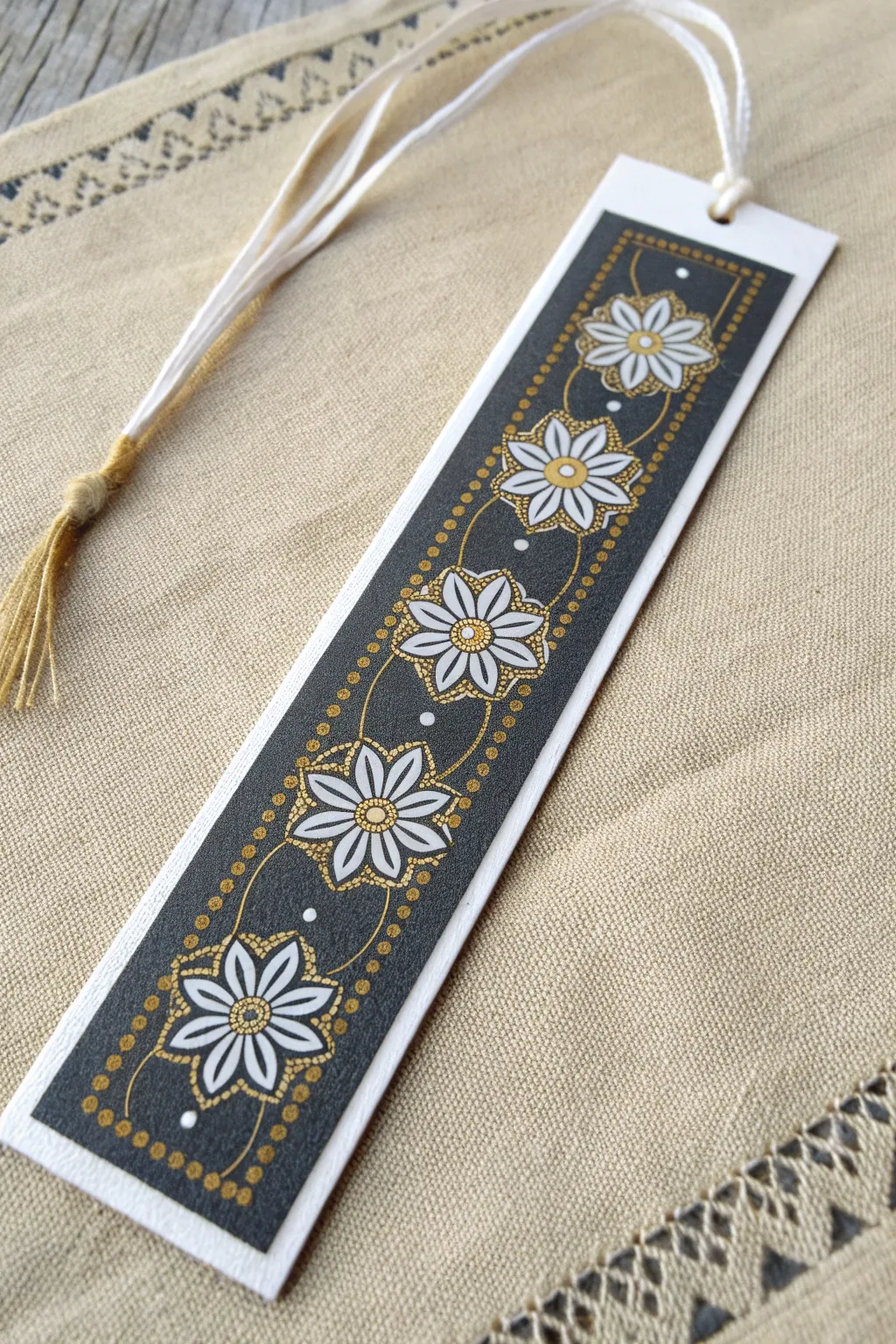 Mini mandala bookmark in white and soft gold on deep charcoal, simple and soothing to paint
