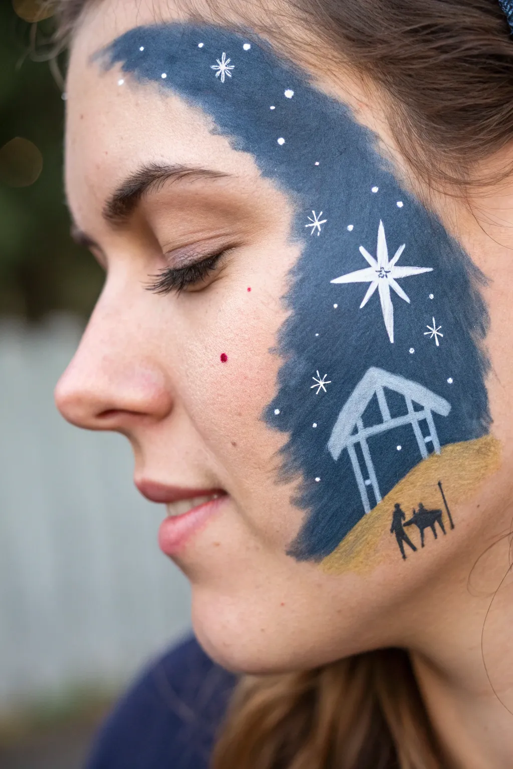 Minimal nativity cheek silhouette beneath a glowing Star of Bethlehem on deep navy night sky