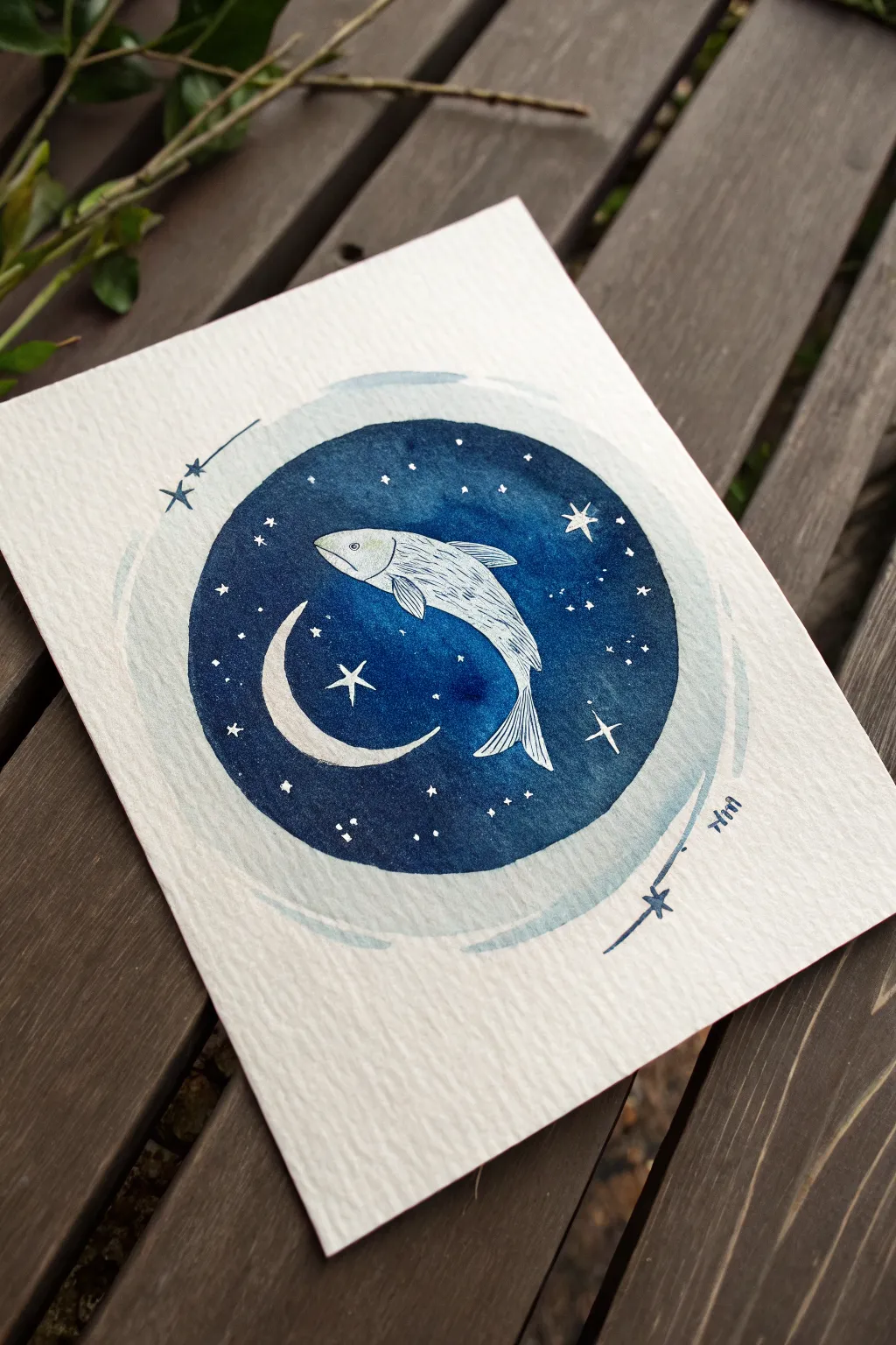 A luminous fish circling a crescent moon in a deep night wash, minimalist and quietly magical.