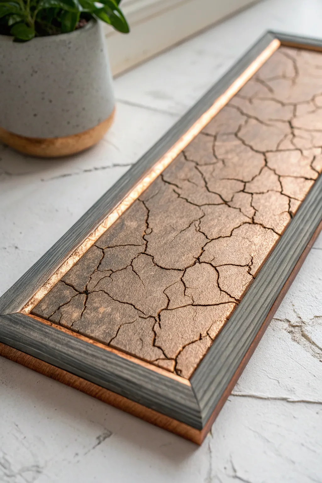 Matte charcoal crackle over copper base, side-lit to reveal beautifully shimmering fissures