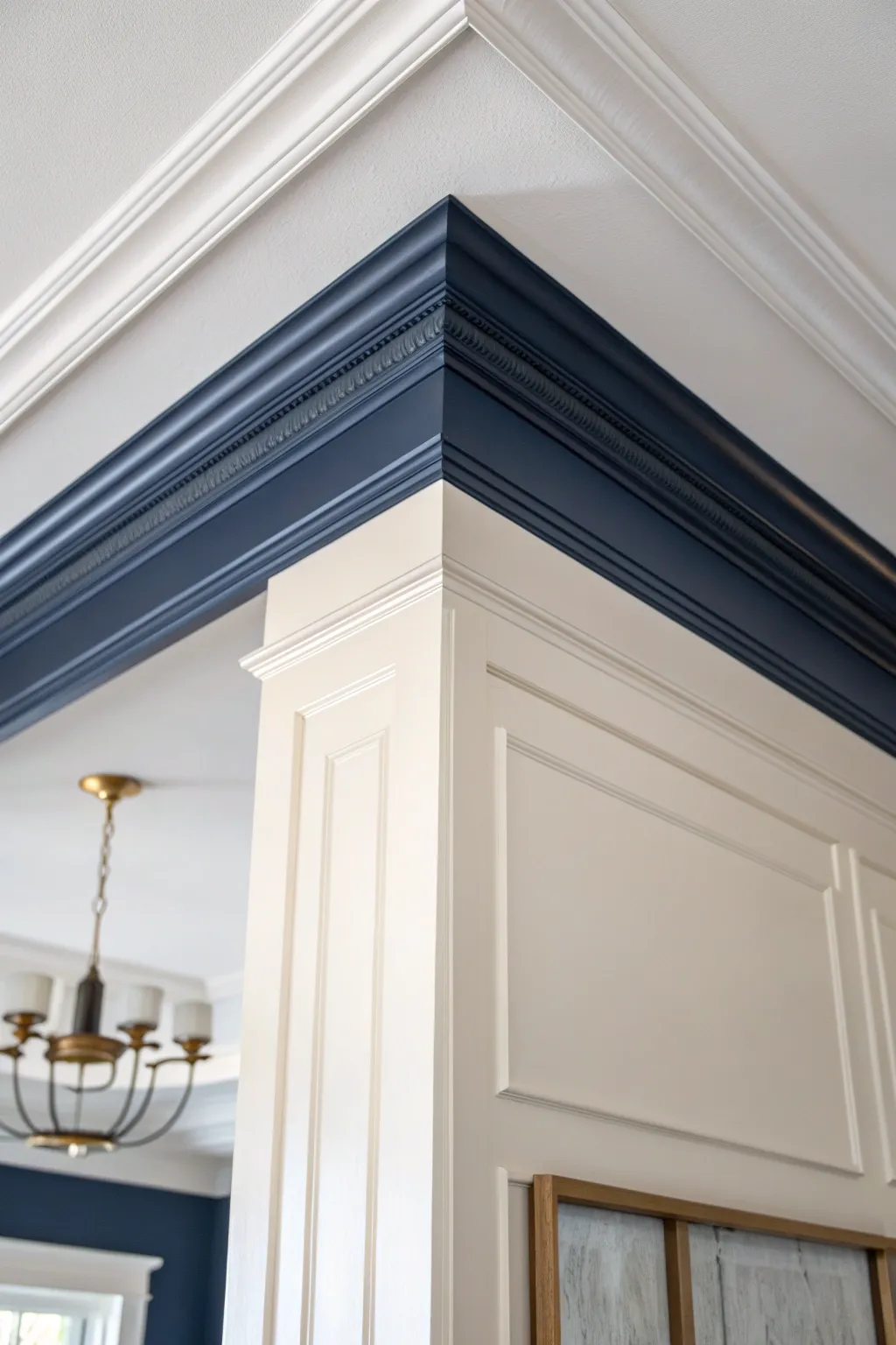 Deep navy crown molding brings sophisticated drama against soft white walls and a warm glow.