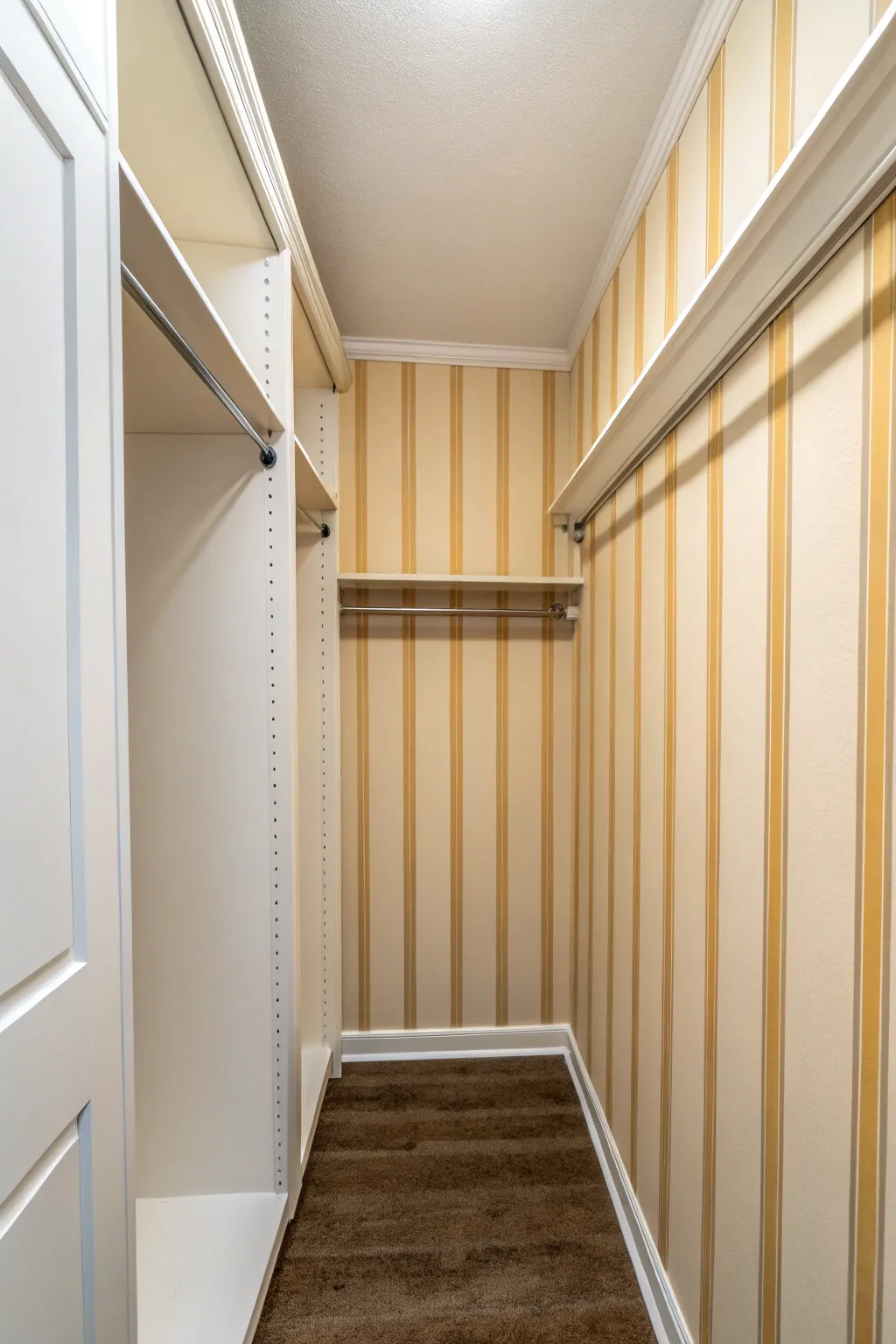 Tone-on-tone vertical stripes and crisp tape lines make a small closet feel taller and airy.