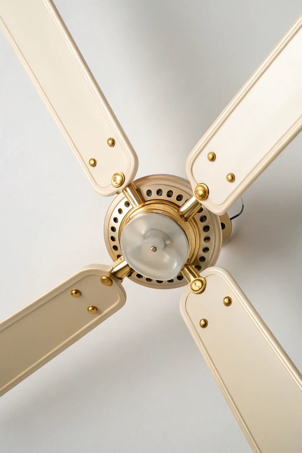 Warm-lit fan blade with fine metallic edge and screw-hole accents for a chic DIY upgrade.