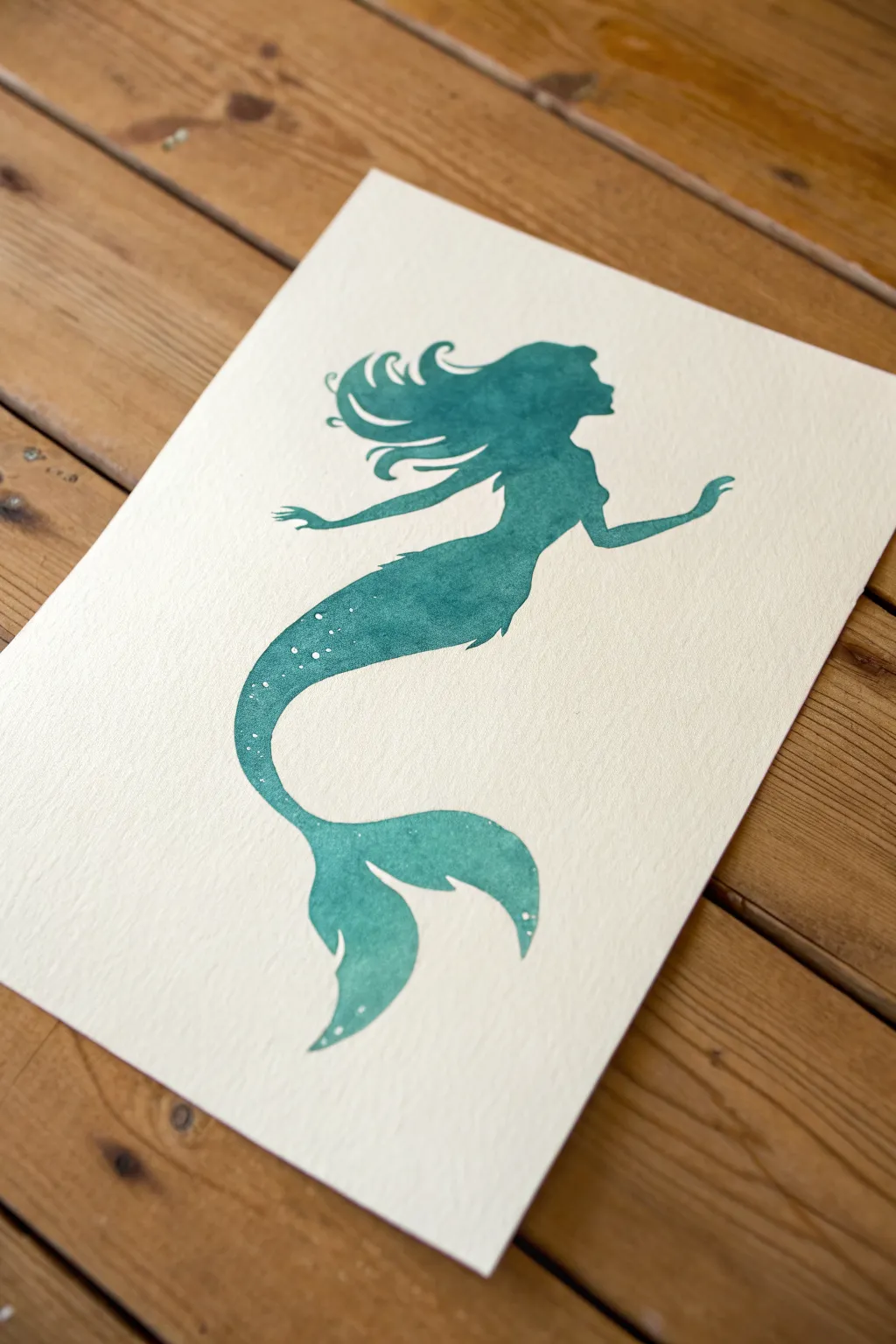 Simple mermaid silhouette with flowing hair and curved tail, perfect for beginner painting practice