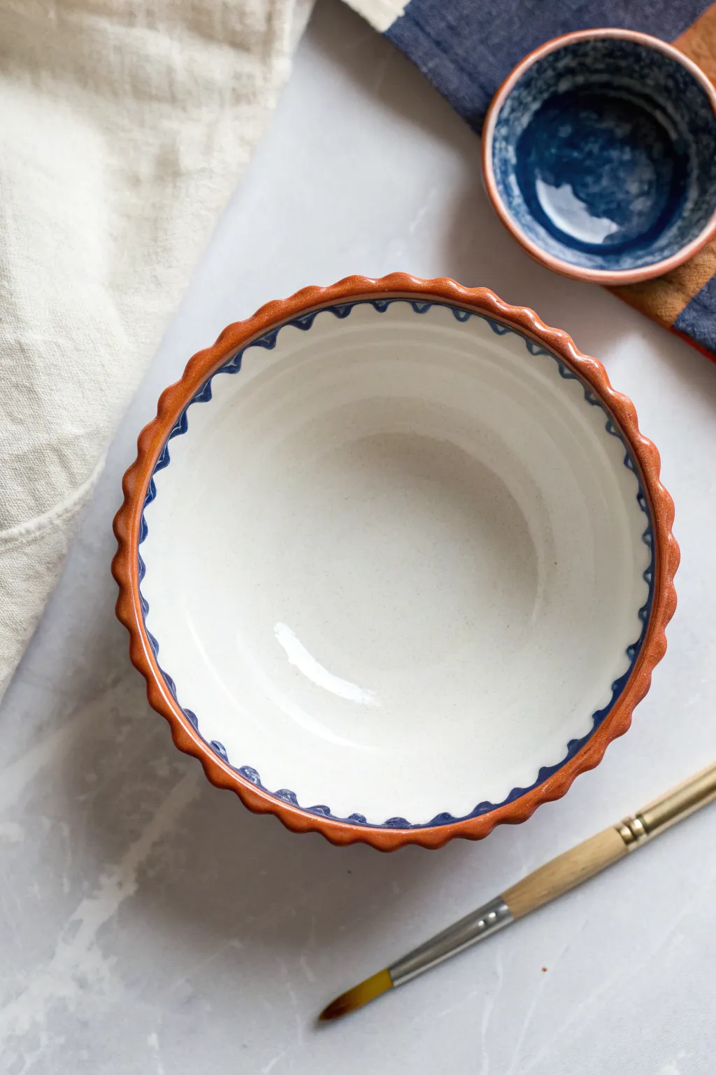 Scalloped rim pottery painting: one bold color and a simple brush stroke to start.