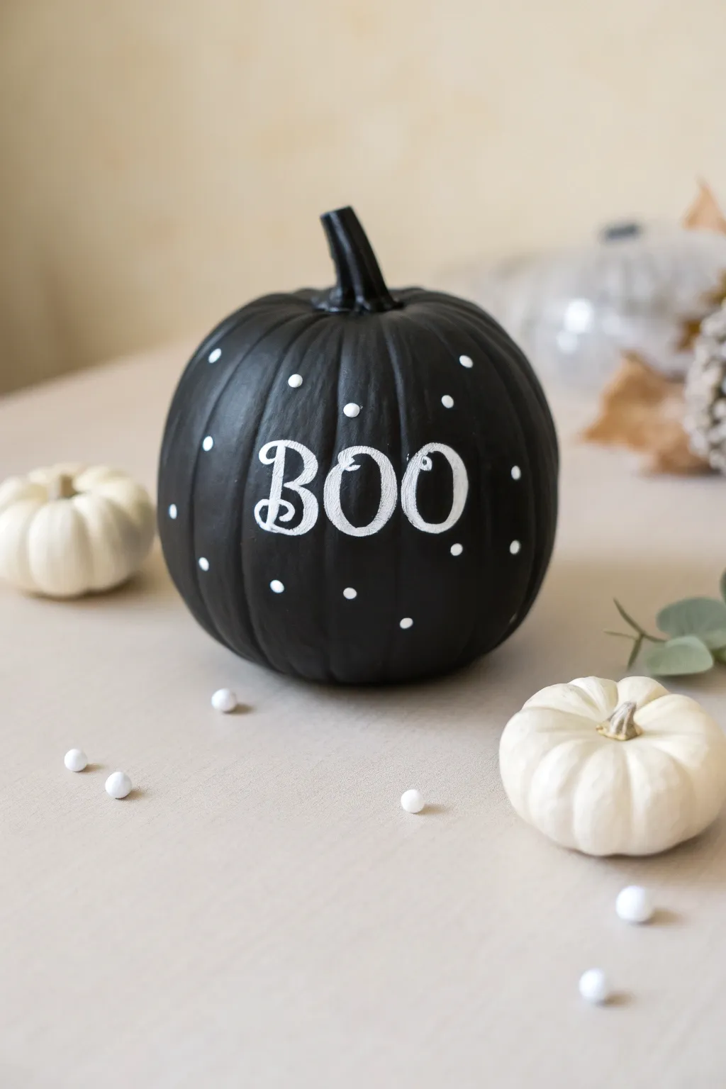 Create a chic spooky vibe with this minimalist matte black and white painted pumpkin.