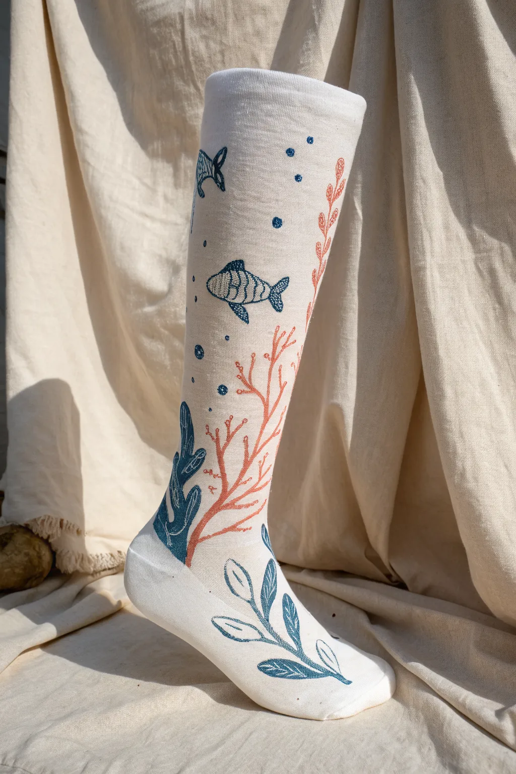 Underwater reef leg cast painting idea in ocean blues, coral shapes and tiny fish silhouettes