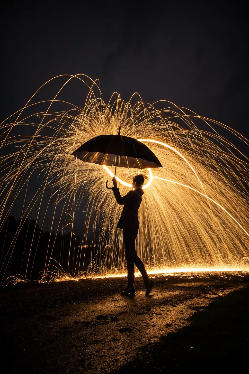 Turn sparks into a golden rain shower with this creative umbrella light painting idea.