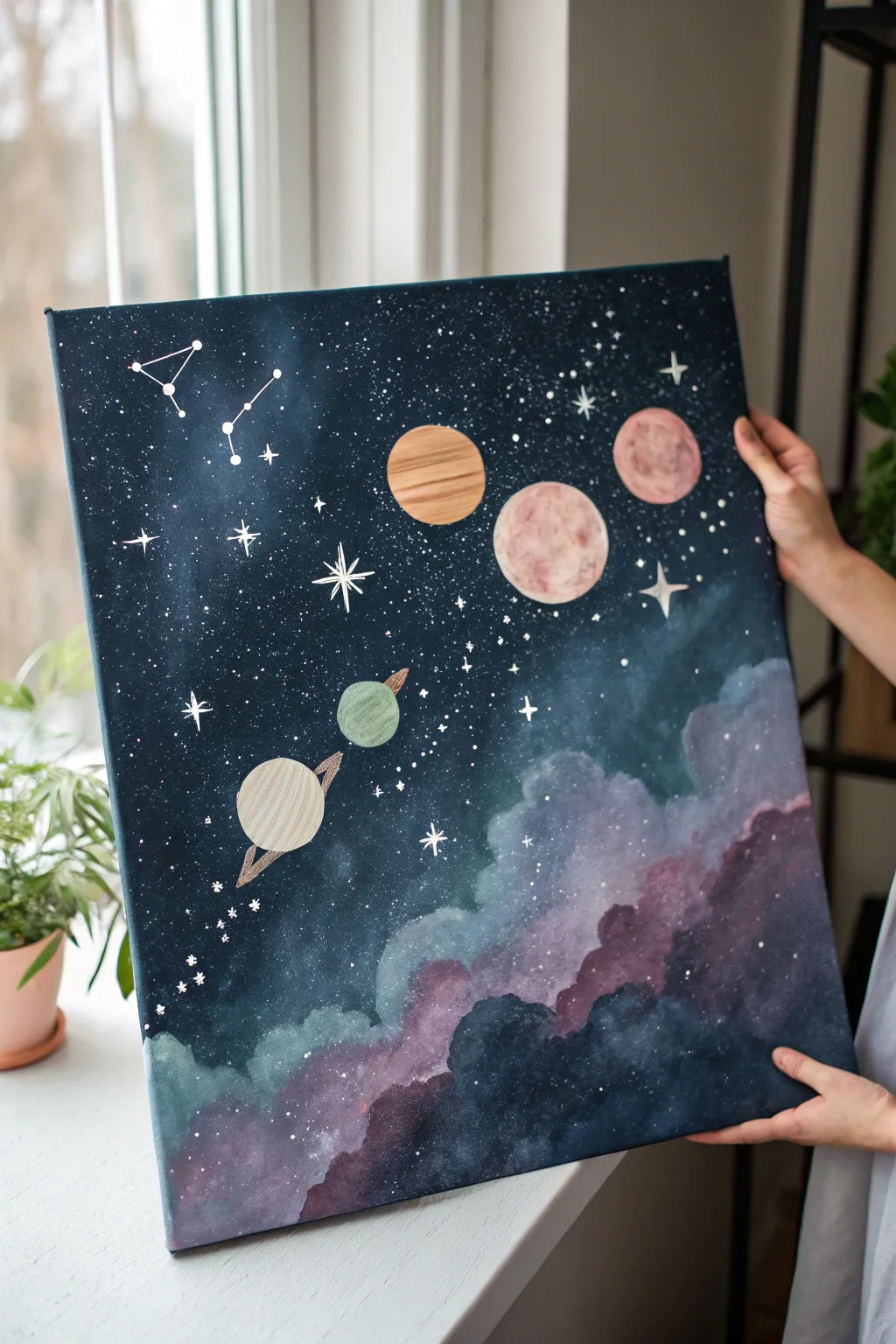 Minimal galaxy canvas with simple planets and splattered stars, a dreamy medium-canvas idea