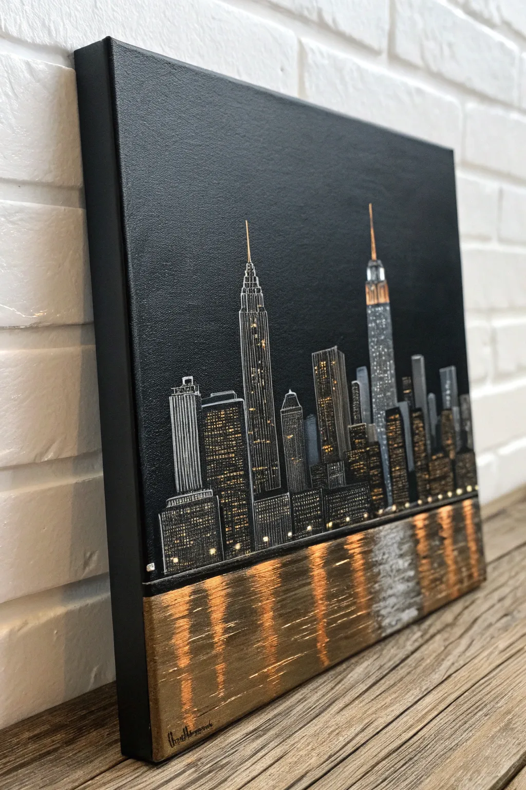 Minimal night skyline in metallic acrylic, shimmering windows and reflections on a dark canvas
