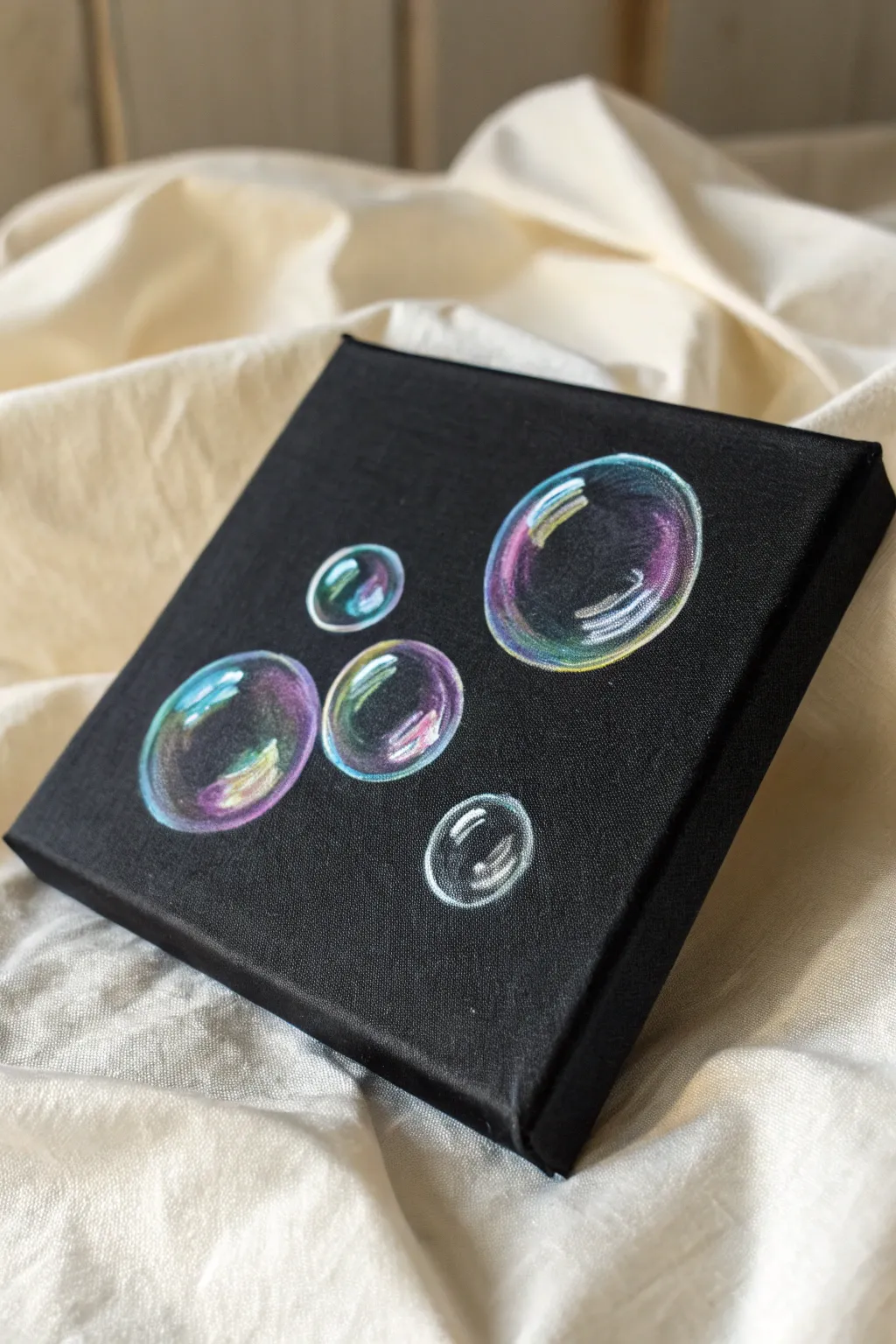 Mini black canvas with iridescent bubble trio, soft white outlines and jewel-toned highlights.