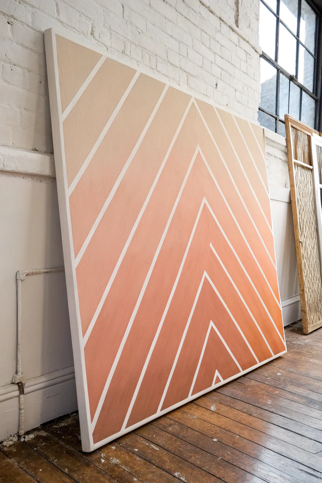 Crisp geometric tape lines over a soft ombre canvas for a minimalist boho statement