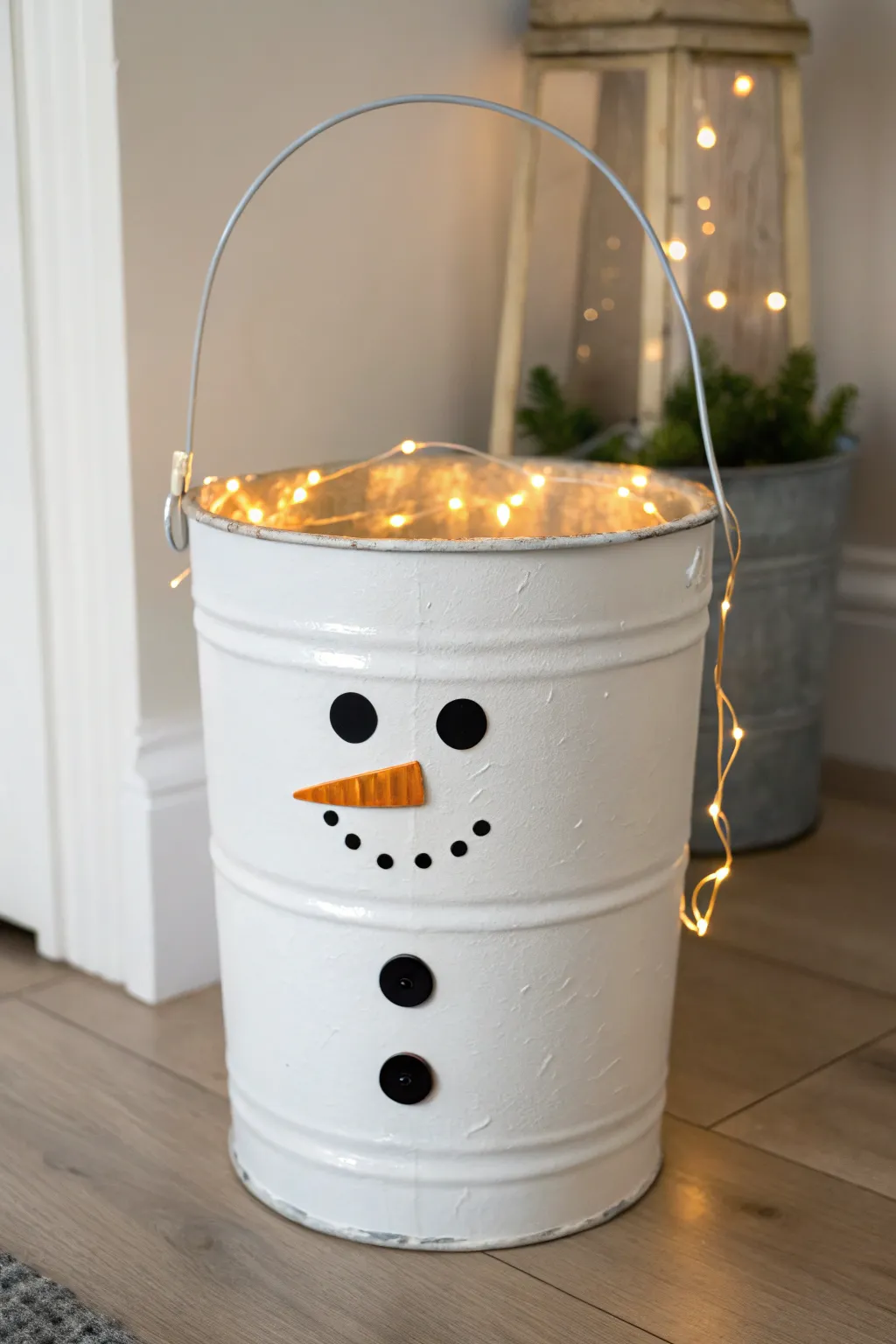 Cozy snowman paint bucket luminary glowing softly, perfect winter craft for your entryway.