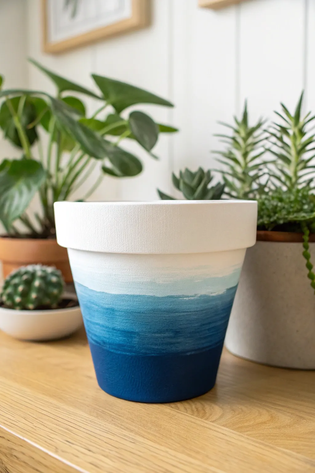 Master the art of color blending with this serene ocean blue to white ombre pot design.