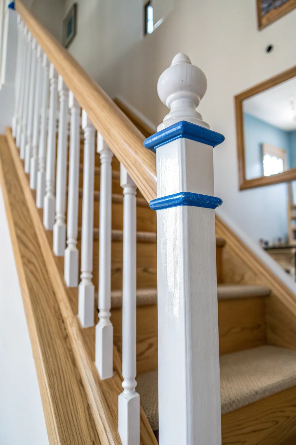 Crisp painters tape edges keep spindle lines sharp where rail meets floor for a flawless finish.