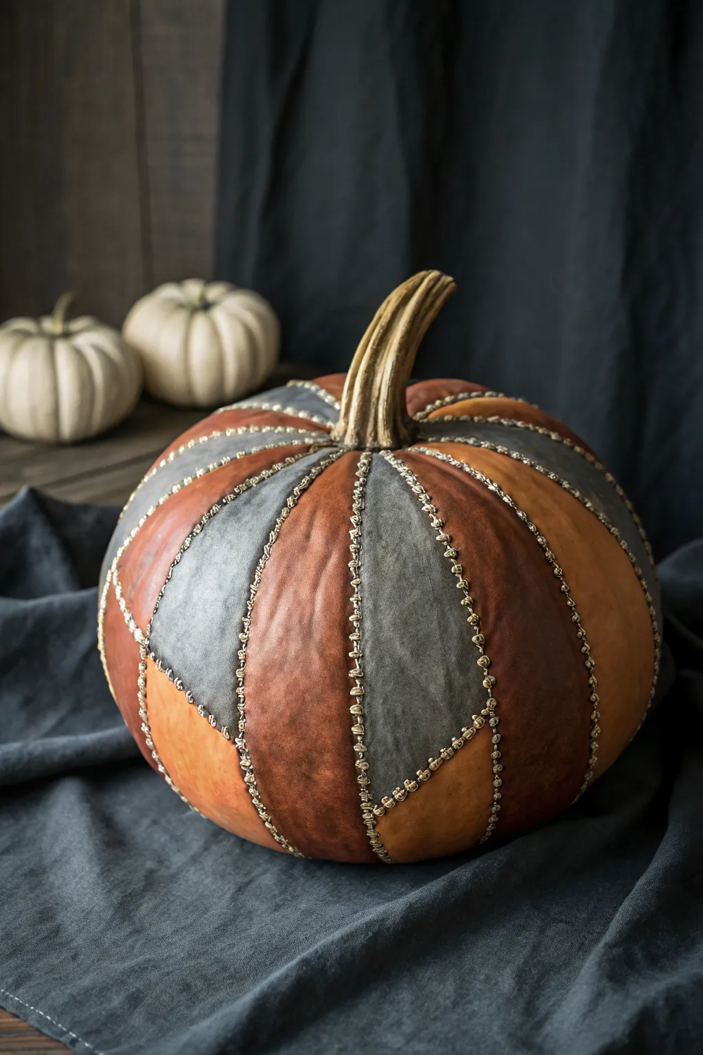 No-carve stitched-up pumpkin: bold faux seams, leather-patch vibe, minimalist contrast.