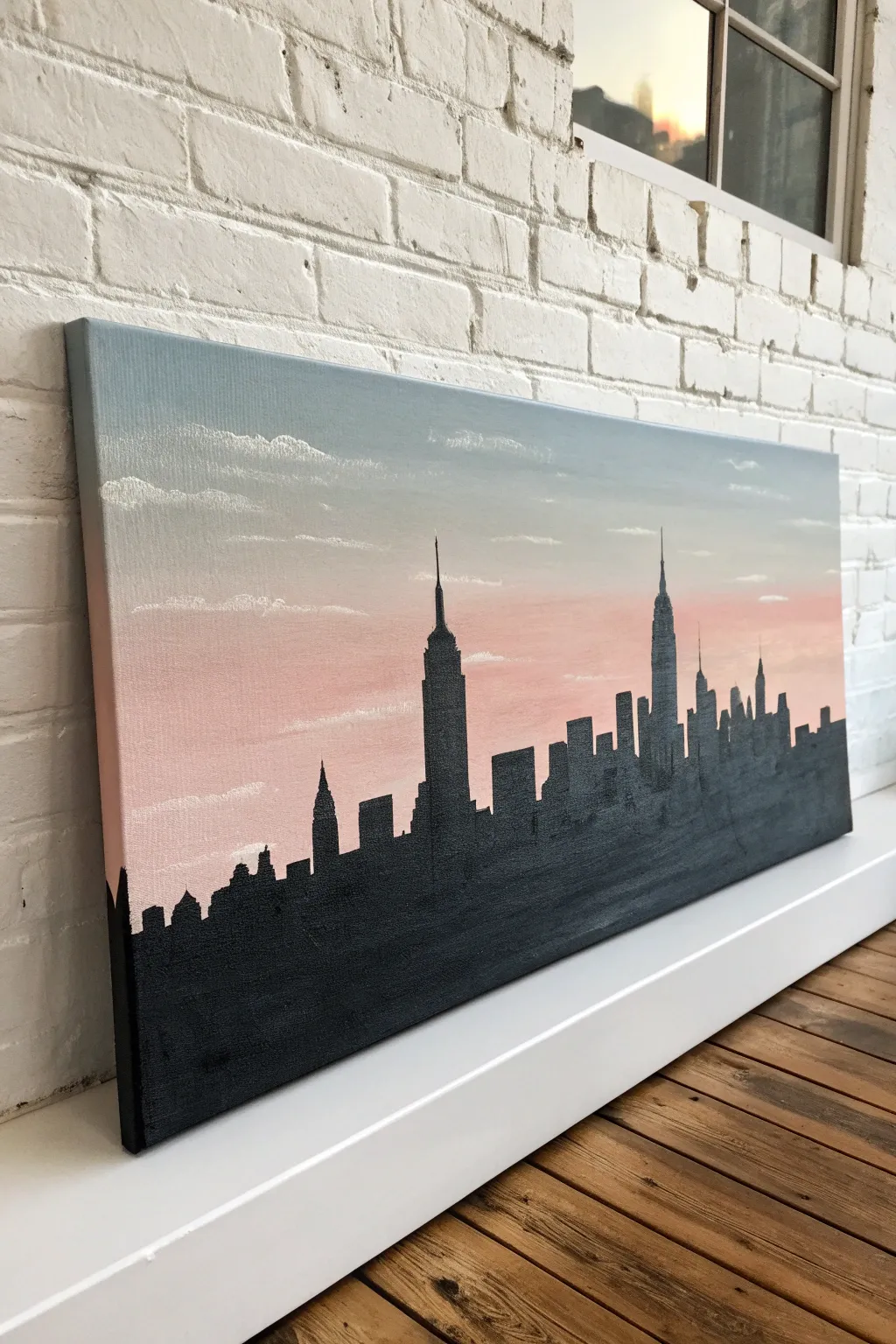 Minimal one-line skyline on a wide rectangle canvas, soft blended sky and tiny window lights.