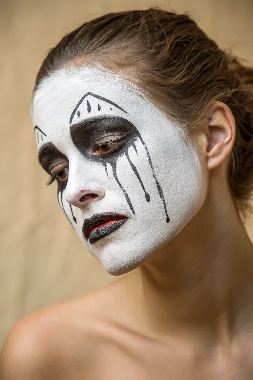 Ghostly dripping mouth face paint with bold contrast, minimalist mood, and an easy spooky finish.