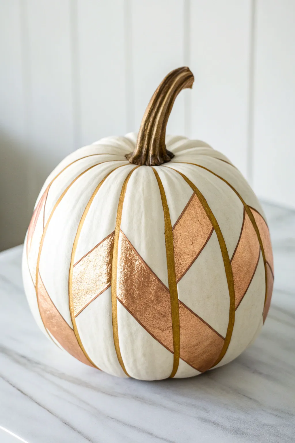 Tall pumpkin with matte neutrals and crisp metallic geometric lines in a minimalist boho style