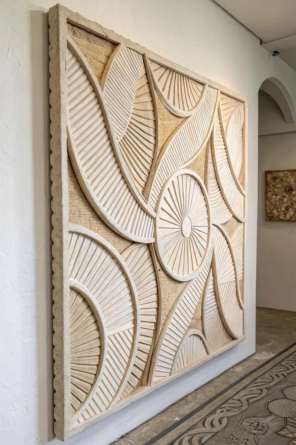 Monochrome cardboard relief artwork with stacked shapes, letting shadows do the talking