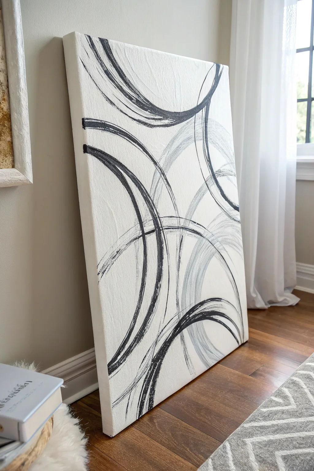 Bold black swirls on a white canvas, softened with gray blends and plenty of calm space.