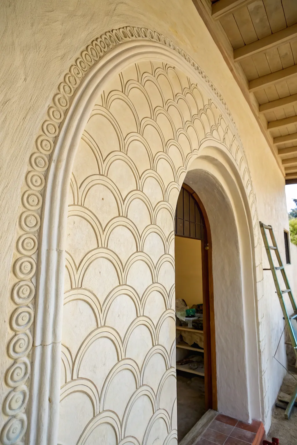 Hand-painted scalloped trim gives a simple archway a soft, boho finish with visible brushwork.