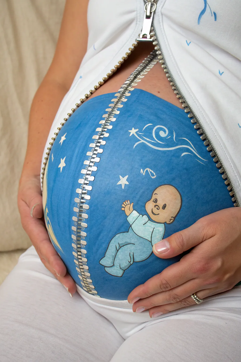 Minimal zipper belly paint opens to a bright blue world with a sweet baby boy surprise inside