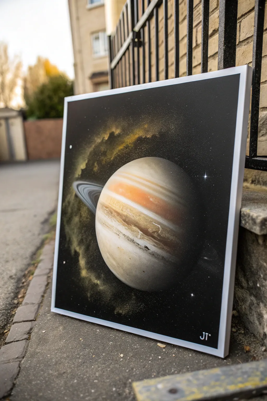 Minimal spray paint ringed planet with a soft overspray halo, crisp ring and high contrast glow