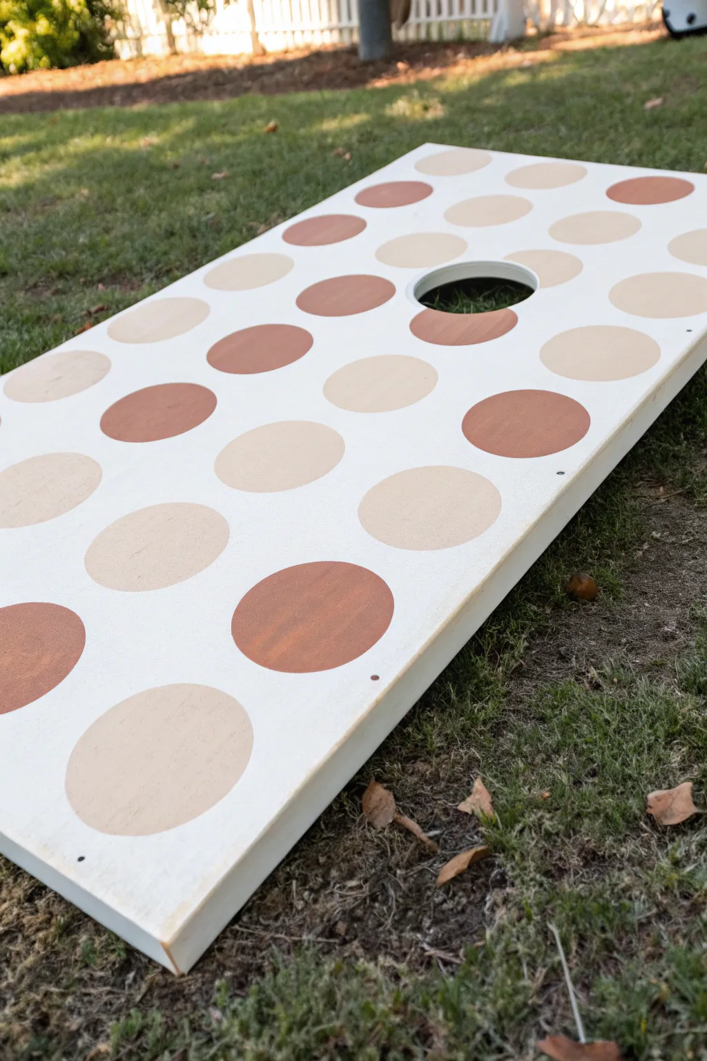 Large-scale polka dots in a clean grid for a bold, minimal cornhole board look