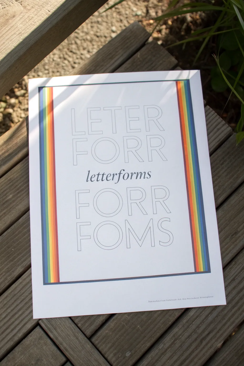 Chunky rainbow stripe lettering that peeks through like woven ribbons, minimal and Pinterest-ready