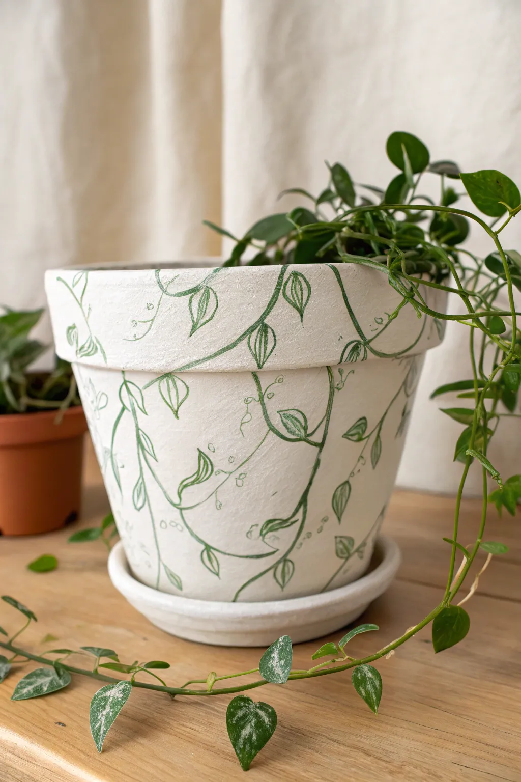 Doodled two-tone vine wrap pot that visually blends into a real trailing plant for boho minimal charm