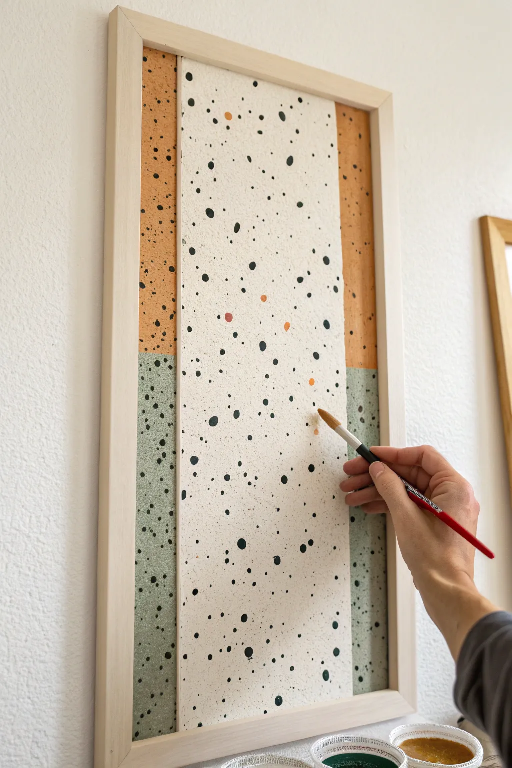 Minimal speckled spatter accent panel with crisp tape edges for an easy modern statement wall
